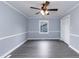 An empty bedroom featuring wood-look flooring, a ceiling fan and fresh, light blue paint at 1729 Augustus Dr, Rocky Mount, NC 27801