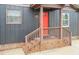 Close-up of a front entrance featuring brick steps, a porch railing, and a vibrant red door at 1729 Augustus Dr, Rocky Mount, NC 27801