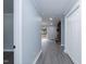 Hallway featuring neutral paint with gray wood-look flooring leading to a living room with a fireplace at 1729 Augustus Dr, Rocky Mount, NC 27801