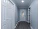Hallway view showing the front door and closet with neutral paint and gray wood-look flooring at 1729 Augustus Dr, Rocky Mount, NC 27801