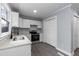 Kitchen with stainless steel appliances, white cabinets, and gray countertop with updated plumbing fixtures at 1729 Augustus Dr, Rocky Mount, NC 27801