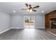 Spacious living room with brick fireplace, gray floors, neutral walls, and a sliding glass door at 1729 Augustus Dr, Rocky Mount, NC 27801