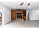 Living room with a brick fireplace, gray floors, neutral walls and an attached bookcase at 1729 Augustus Dr, Rocky Mount, NC 27801