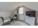 Functional attic space with a table and chairs and tv at 2010 Twin Acres Rd, Clayton, NC 27520