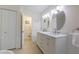 Bathroom showcases a double vanity with modern fixtures, spacious countertop, and ample storage with tile flooring at 2010 Twin Acres Rd, Clayton, NC 27520