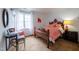 Cozy bedroom with a wooden bed frame and a bedside table with lamp at 2010 Twin Acres Rd, Clayton, NC 27520