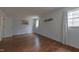Bedroom showcasing hardwood floors, natural light from two windows, and neutral wall décor at 2010 Twin Acres Rd, Clayton, NC 27520