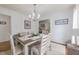 Bright dining room featuring a stylish chandelier, dining table set for six, and 'Gather Here' wall decor at 2010 Twin Acres Rd, Clayton, NC 27520