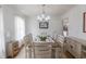 Bright dining room with chandelier and seating for six around a wooden table at 2010 Twin Acres Rd, Clayton, NC 27520