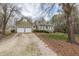 Charming home featuring a two-car garage and a welcoming front porch, surrounded by mature trees at 2010 Twin Acres Rd, Clayton, NC 27520