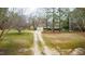 Beautiful home with an expansive front yard and long driveway, surrounded by lush trees and greenery at 2010 Twin Acres Rd, Clayton, NC 27520