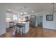 Spacious kitchen with white cabinets, quartz countertops, stainless appliances, island with stools and stylish pendant lights at 2010 Twin Acres Rd, Clayton, NC 27520
