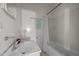 A clean, simple bathroom with a shower-tub combination and essential fixtures in neutral tones at 219 N Richardson Ave, Nashville, NC 27856