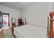 A spacious bedroom with a wooden bed frame, vintage dresser, and a doorway to an adjacent room at 219 N Richardson Ave, Nashville, NC 27856