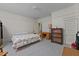 Spacious bedroom with carpet, featuring a double bed, dresser, bookcase, and neutral-colored walls at 219 N Richardson Ave, Nashville, NC 27856