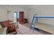 An open bedroom featuring vintage furnishings and a metal frame bunkbed at 219 N Richardson Ave, Nashville, NC 27856