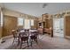 Dining room needing repairs, features a table and chairs, worn walls, and a view into an adjacent room at 219 N Richardson Ave, Nashville, NC 27856