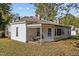 Rear view of home featuring a covered back porch and mature trees at 219 N Richardson Ave, Nashville, NC 27856