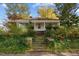 Inviting front entrance with brick steps leading to a cozy porch, surrounded by lush ivy at 219 N Richardson Ave, Nashville, NC 27856
