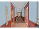Hallway with wooden floor and light blue walls with red trim at 219 N Richardson Ave, Nashville, NC 27856