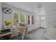 Bright sunroom features natural light with multiple windows and white painted wood paneling and wicker furniture at 219 N Richardson Ave, Nashville, NC 27856