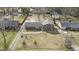 Aerial view of brick home with a backyard basketball court and detached garage at 2605 Sumac Ln, Burlington, NC 27215
