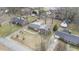 Wide aerial view of a residential neighborhood featuring a brick home with a basketball court at 2605 Sumac Ln, Burlington, NC 27215