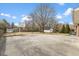 This concrete backyard features a basketball hoop and storage shed at 2605 Sumac Ln, Burlington, NC 27215
