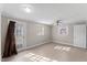 Basement featuring neutral paint, tiled floors, a ceiling fan, and access to the exterior at 2605 Sumac Ln, Burlington, NC 27215