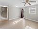 Spacious basement featuring neutral paint, tiled floors, a ceiling fan, and access to the exterior at 2605 Sumac Ln, Burlington, NC 27215