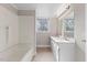 Bright bathroom with dual sinks, modern vanity, tub, and a large mirror at 2605 Sumac Ln, Burlington, NC 27215