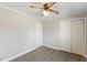 This bedroom features neutral walls, vinyl flooring, a closet and a ceiling fan at 2605 Sumac Ln, Burlington, NC 27215