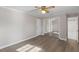 Bedroom featuring wood-look floors, large closet, with ceiling fan and light at 2605 Sumac Ln, Burlington, NC 27215