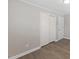 Bedroom features wood-look floors, with a closet and a door at 2605 Sumac Ln, Burlington, NC 27215
