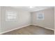 Bedroom featuring wood-look floors, and two bright windows at 2605 Sumac Ln, Burlington, NC 27215