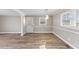 Dining area featuring luxury vinyl plank flooring, wainscoting, modern lighting, and natural light at 2605 Sumac Ln, Burlington, NC 27215