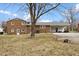 Brick home exterior with a carport and a large backyard at 2605 Sumac Ln, Burlington, NC 27215