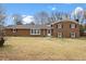 Front exterior of a two-story brick home featuring double-hung windows and a manicured lawn at 2605 Sumac Ln, Burlington, NC 27215