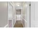 A hallway leads to the stairwell, displaying modern neutral walls and vinyl floors at 2605 Sumac Ln, Burlington, NC 27215