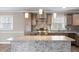 Modern kitchen featuring stainless steel appliances, granite countertops, stylish backsplash, and pendant lighting at 2605 Sumac Ln, Burlington, NC 27215