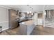 Modern kitchen with island and breakfast bar, stainless appliances and adjacent staircase at 2605 Sumac Ln, Burlington, NC 27215
