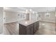 Open-concept living room featuring an island, hardwood floors, neutral colors, and natural light at 2605 Sumac Ln, Burlington, NC 27215