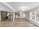 Open floor plan with luxury vinyl plank flooring, kitchen, staircase, and light fixtures at 2605 Sumac Ln, Burlington, NC 27215
