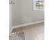 Living room features neutral paint, ceramic tile floors, and a window at 2605 Sumac Ln, Burlington, NC 27215