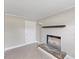 The spacious living room features a decorative fireplace, neutral paint, and lots of light at 2605 Sumac Ln, Burlington, NC 27215