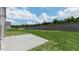 Landscaped backyard with retaining wall and patio, offering a serene outdoor space at 266 Hanging Elm Ln, Fuquay Varina, NC 27526