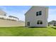 New home backyard with a concrete patio, sliding glass door, and professional landscape at 266 Hanging Elm Ln, Fuquay Varina, NC 27526
