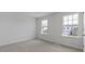 Bright bedroom featuring neutral walls, plush carpeting, and two windows at 266 Hanging Elm Ln, Fuquay Varina, NC 27526