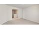 A spacious, carpeted bedroom with neutral walls is adjacent to a carpeted staircase landing at 266 Hanging Elm Ln, Fuquay Varina, NC 27526