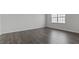 Spacious bedroom features hardwood floors and natural light from a large window at 266 Hanging Elm Ln, Fuquay Varina, NC 27526